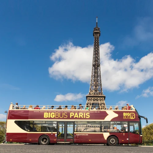 Big Bus Tours Paris campaign creative showing a bus below the Eiffel Tower